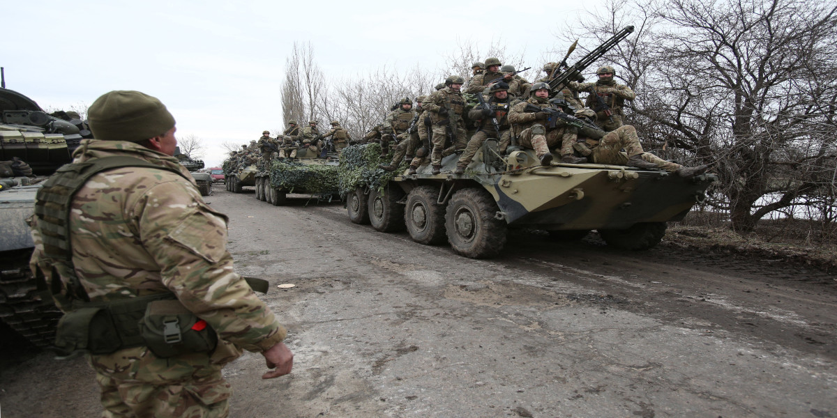 Ukrainian soldiers sit atop a tank in the thick of the war